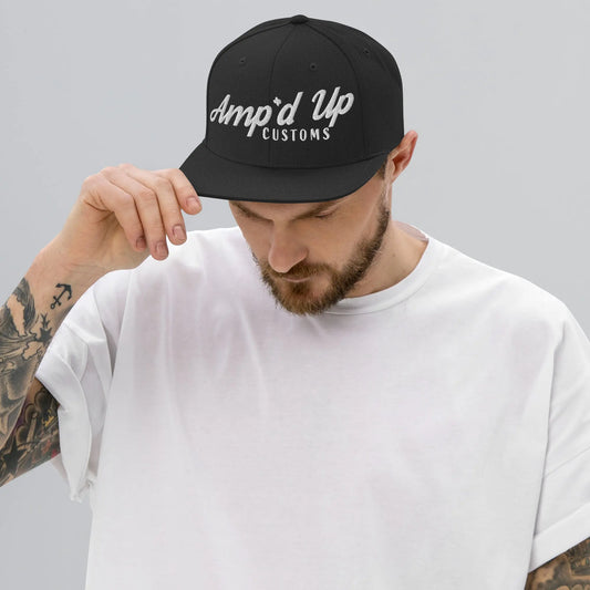 Man wearing an Amp'd Up Custom Snapback Hat in black showcasing stylish logo design