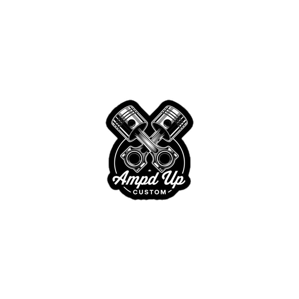 Ampd Up Customs Piston sticker featuring crossed pistons and a bold logo design