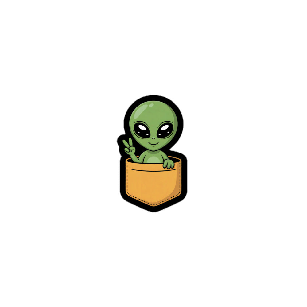 Cute Alien sticker showing a small green alien making a peace sign while sitting in a brown pocket