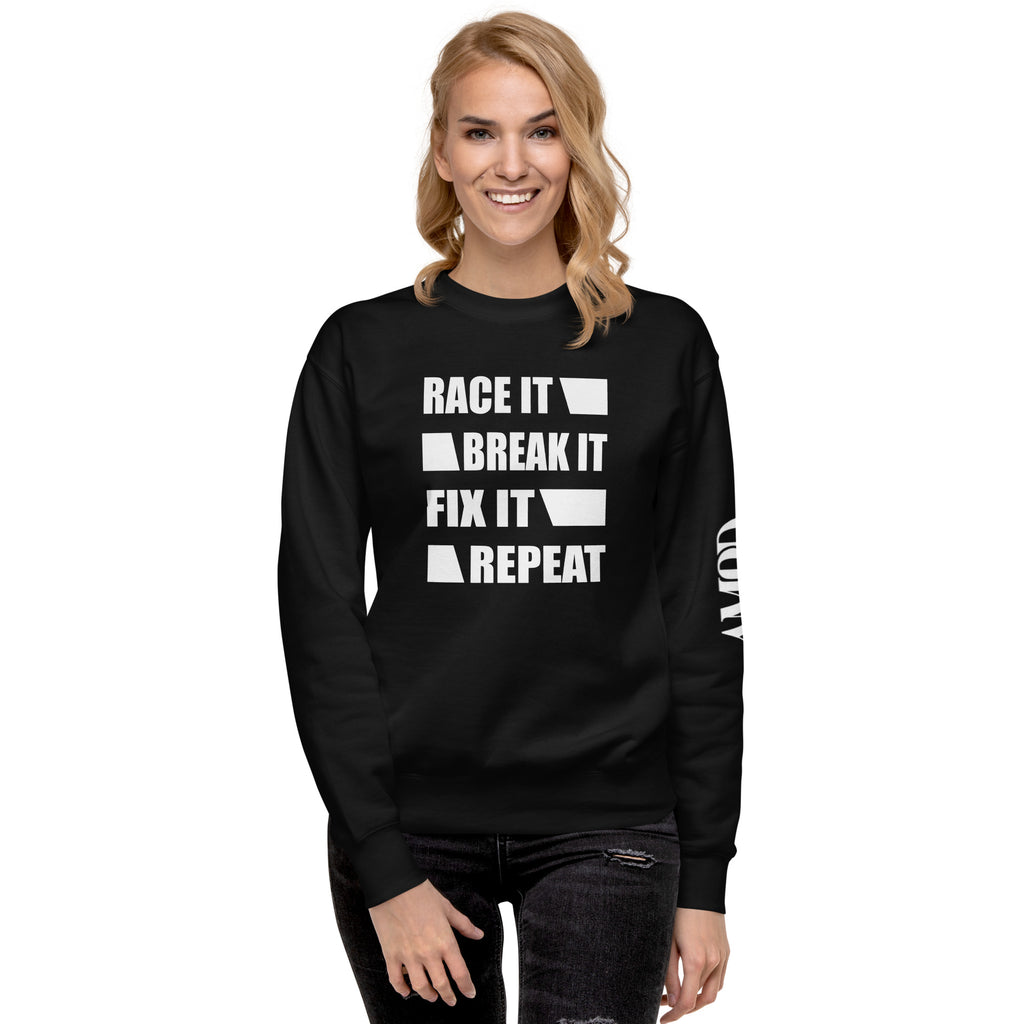 Woman wearing Race It Break It Fix It Repeat Sweatshirt | AMPD in black with bold white text