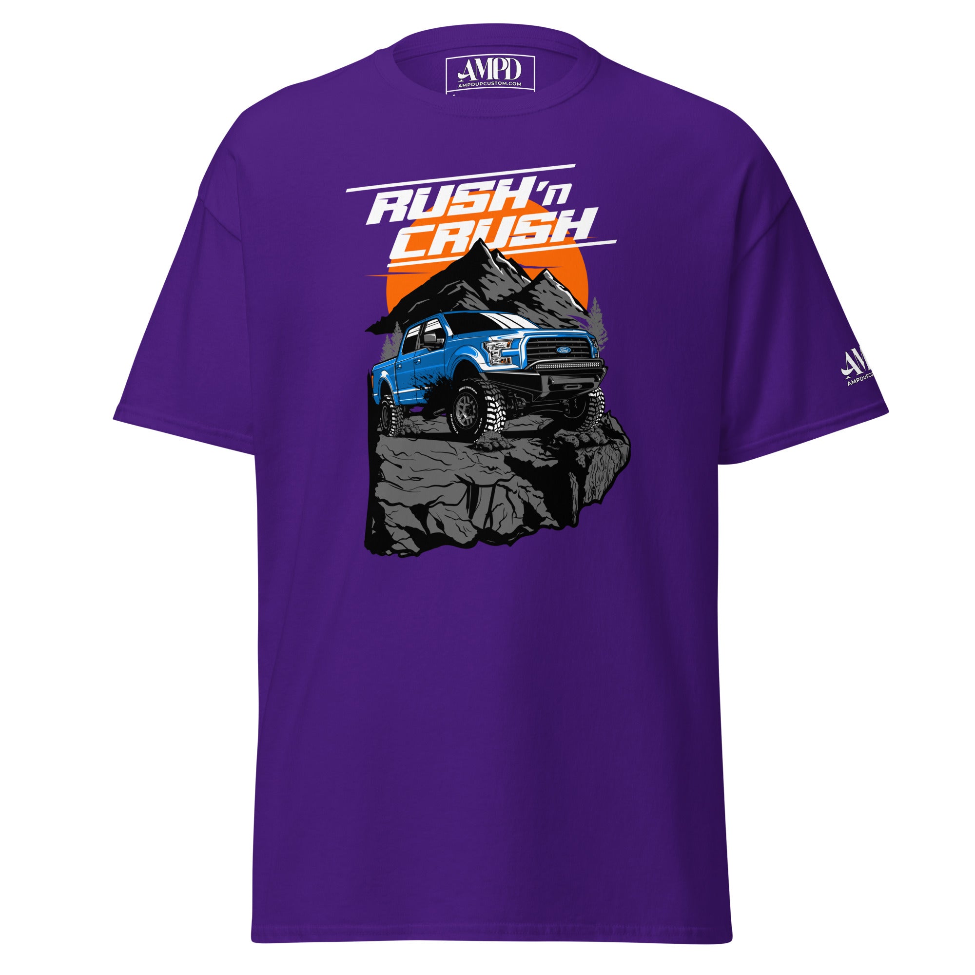Rush n Crush Off-Road T-Shirt | AMPD in purple featuring a blue truck on rocks with a mountain backdrop