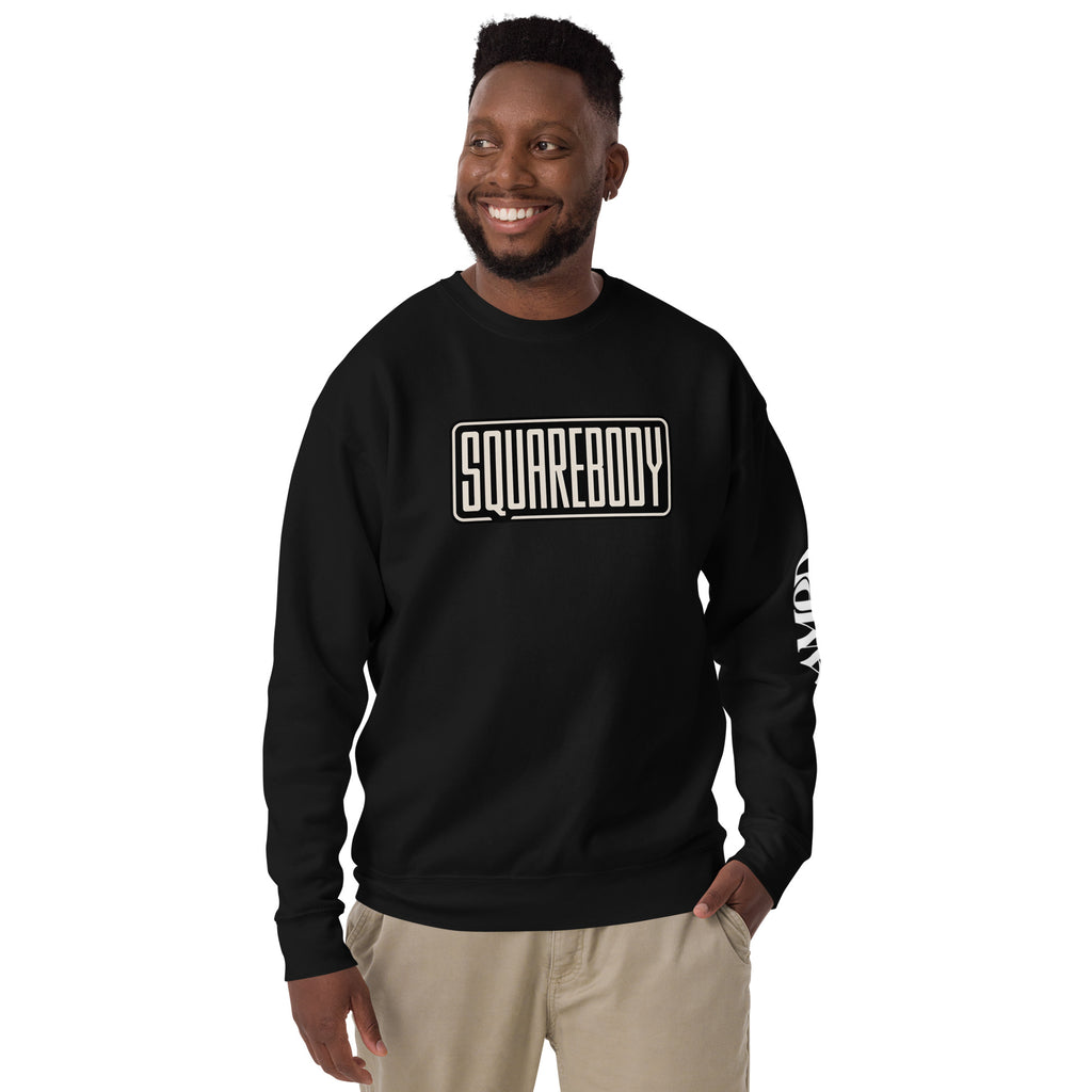 Man wearing black Squarebody Graphic Sweatshirt | AMPD with bold lettering for stylish comfort