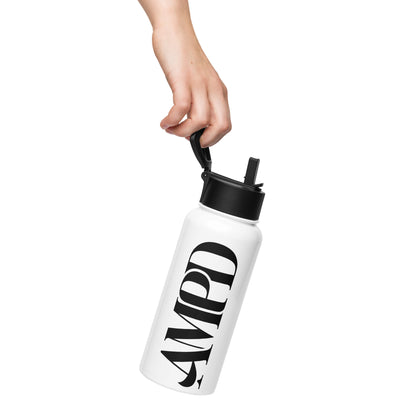 AMPD Stainless steel water bottle with a straw lid held by a hand for easy carrying