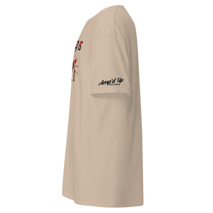 Side view of beige Amp'd Up Custom All I Need Is Love T-Shirt with sleeve logo