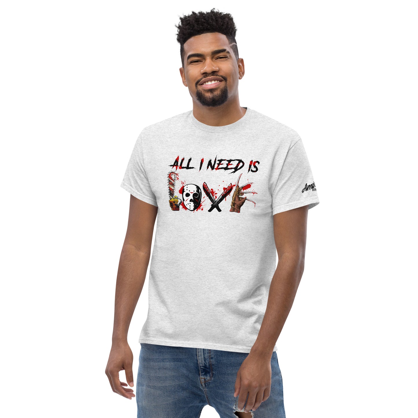 Man wearing white All I Need Is Love T-Shirt with graphic text and Amp'd Up Custom logo on sleeve