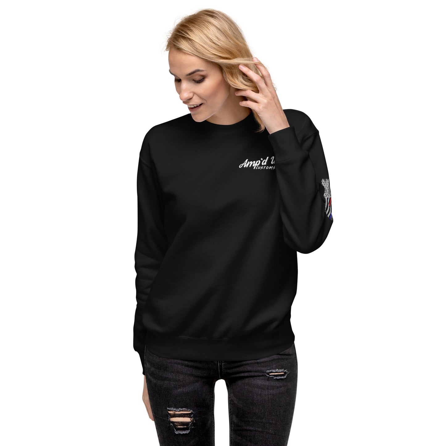 Woman wearing Amp'd Up Custom Classic Sweatshirt black crewneck with white chest logo and sleeve graphic with ripped jeans