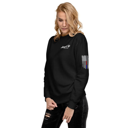 Female model wearing Amp'd Up Custom Classic Sweatshirt black crewneck with chest logo and thin blue red flag on sleeve