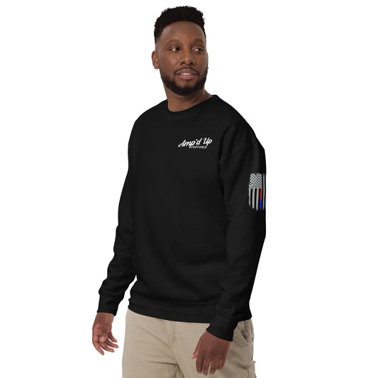 Male model wearing black crewneck Amp'd Up Custom Classic Sweatshirt with white chest logo and thin blue line flag sleeve patch