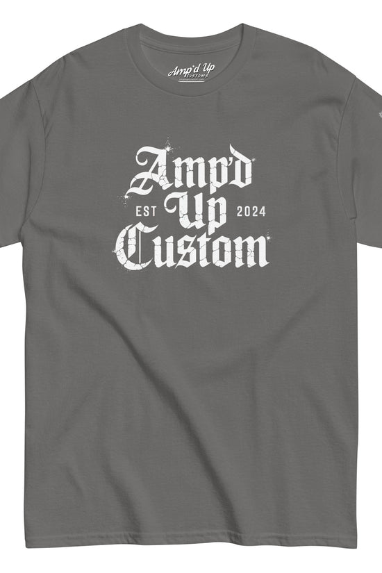 Gray crewneck T-shirt displaying Amp'd Up Custom EST2024 T-Shirt with white gothic logo center and flag sleeve patch
