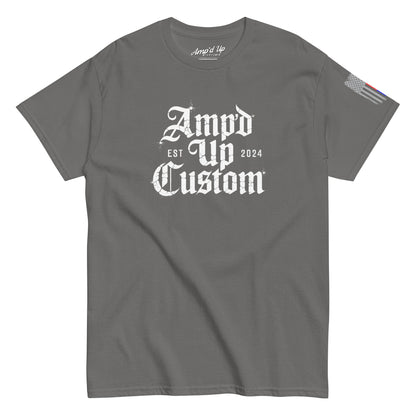Gray crewneck T-shirt displaying Amp'd Up Custom EST2024 T-Shirt with white gothic logo center and flag sleeve patch