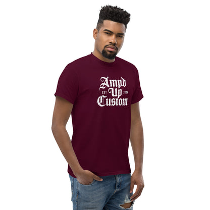 Male model wearing burgundy Amp'd Up Custom EST2024 T-Shirt with white gothic logo and casual fit jeans
