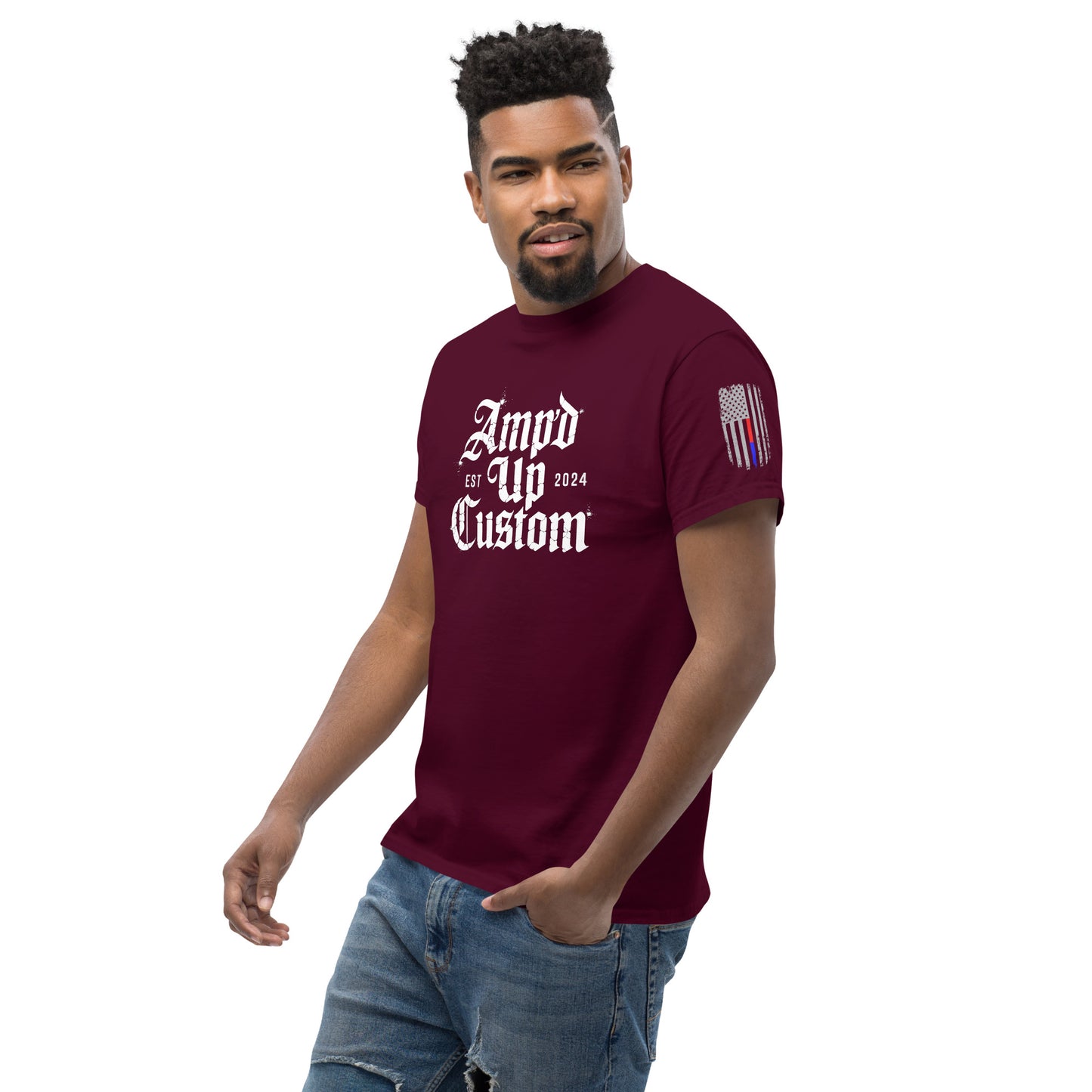 Male model wearing maroon Amp'd Up Custom EST2024 T-Shirt with white gothic logo and stylized flag sleeve