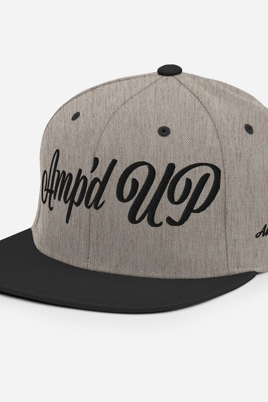 Amp'd Up cursive 3D Puff Snapback Hat in gray with black brim and stylish design