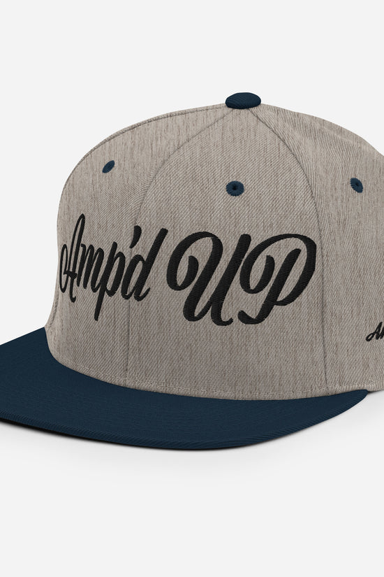 Amp'd Up cursive 3D Puff Snapback Hat in gray and navy with stylish design elements