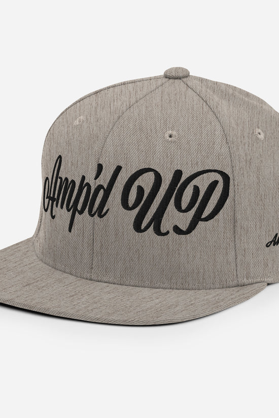 Amp'd Up cursive 3D Puff Snapback Hat in gray with stylish black lettering