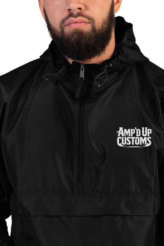 Amp'd Up Custom Embroidered Champion Packable Jacket in black worn by model outdoors
