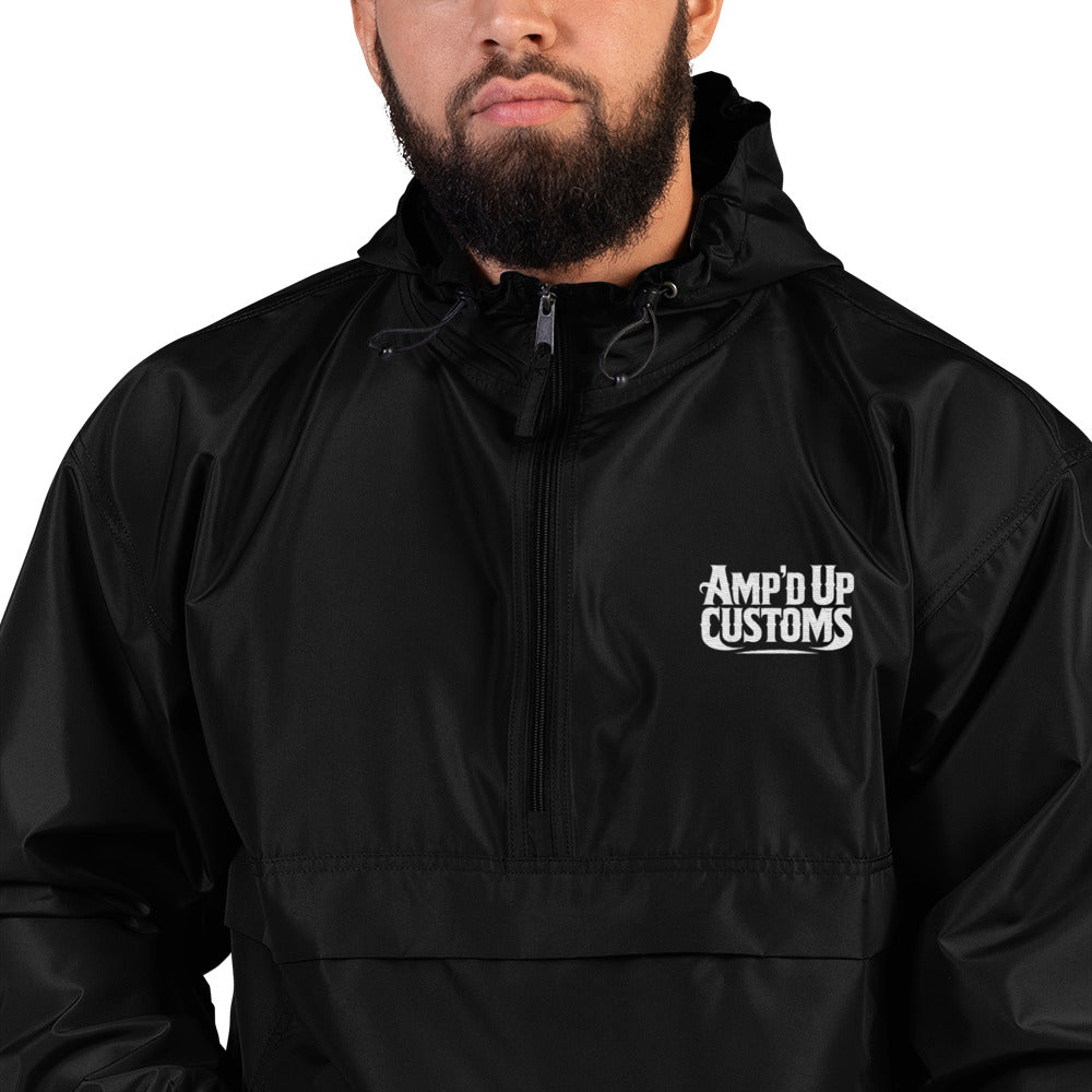 Amp'd Up Custom Embroidered Champion Packable Jacket in black worn by model outdoors