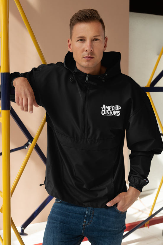Amp'd Up Custom Embroidered Champion Packable Jacket worn by a man against a construction backdrop