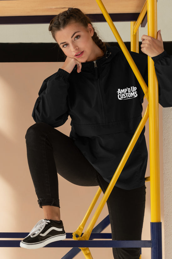 Model wearing Ampd Up Custom Embroidered Champion Packable Jacket in black, styled with casual jeans