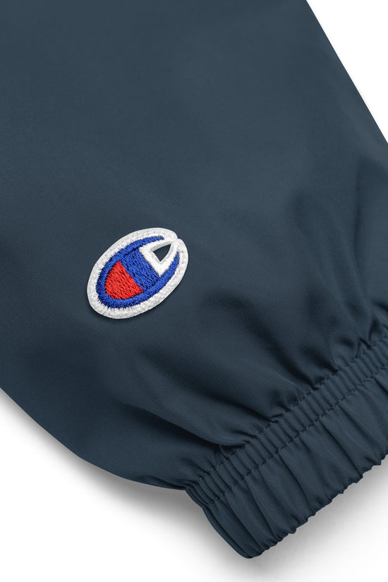 Close-up of Ampd Up Custom Embroidered Champion Packable Jacket showing elastic cuffs and logo detail
