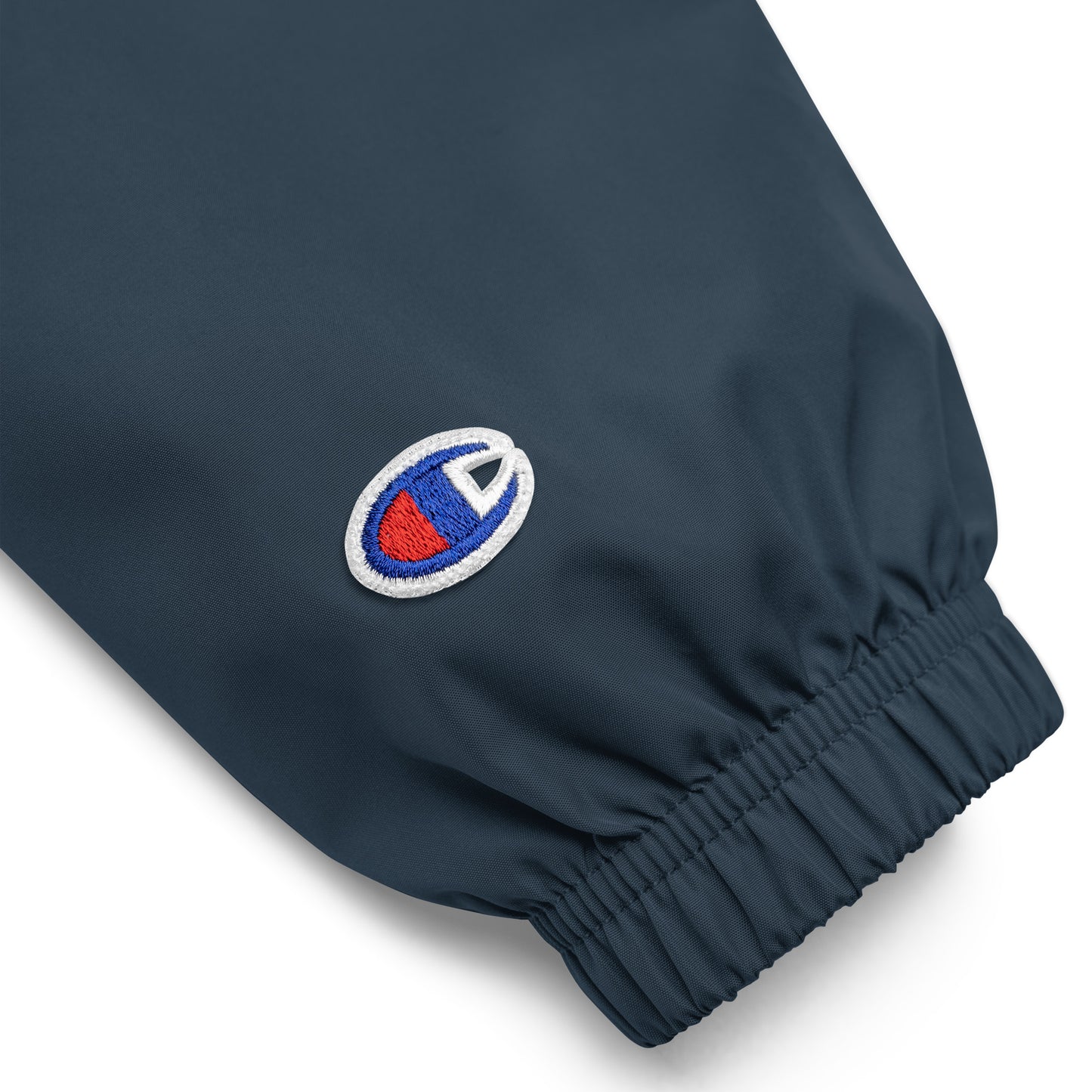 Close-up of Ampd Up Custom Embroidered Champion Packable Jacket showing elastic cuffs and logo detail