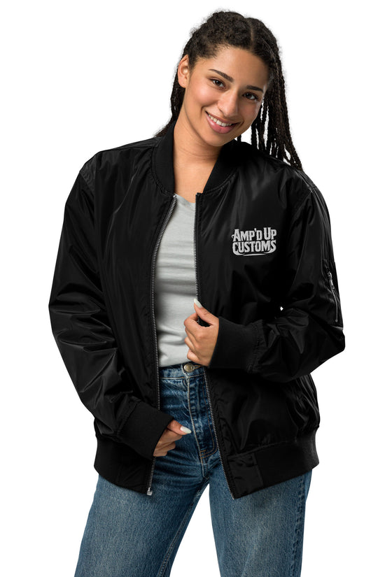 Ampd Up Custom Premium recycled bomber jacket in black worn by a smiling woman, featuring a stylish design