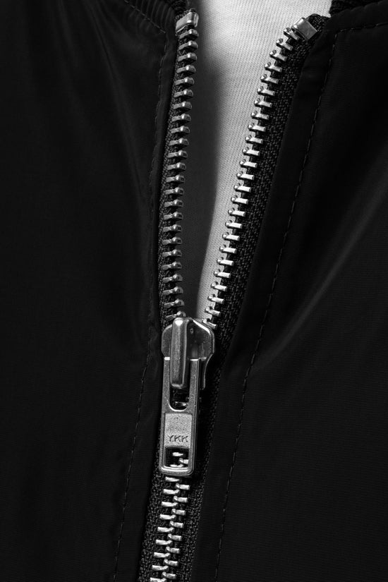 Close-up of the zipper on Ampd Up Custom Premium recycled bomber jacket in black