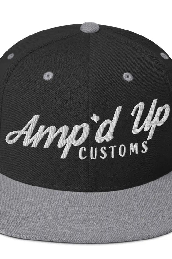 Amp'd Up Custom Snapback Hat features a black body with gray brim and stylish embroidered logo