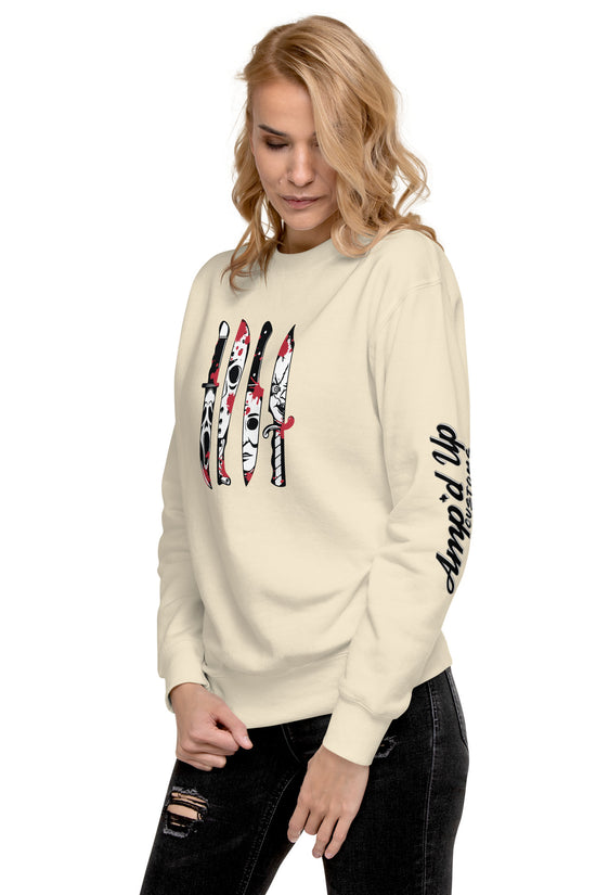 Woman wearing Amp'd Up Custom Horror Movie Classic Knives Sweatshirt in beige with knife graphic and sleeve logo