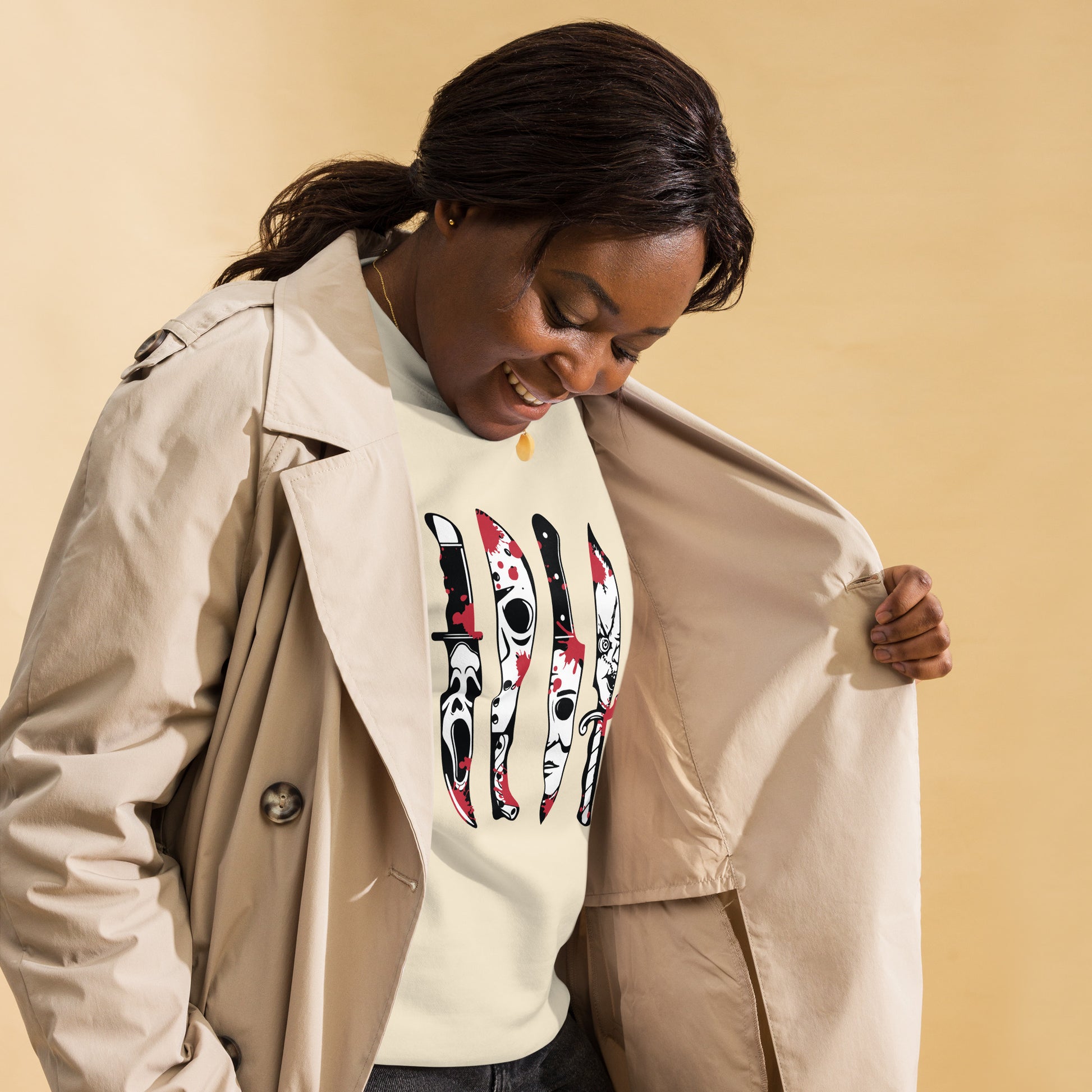 Woman wearing Horror Movie Classic Knives Sweatshirt featuring iconic horror knife designs under beige trench coat