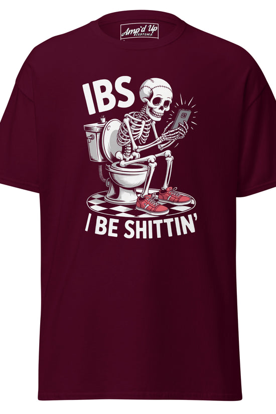 Maroon I Be Shittin T-Shirt featuring a skeleton sitting on a toilet with a phone