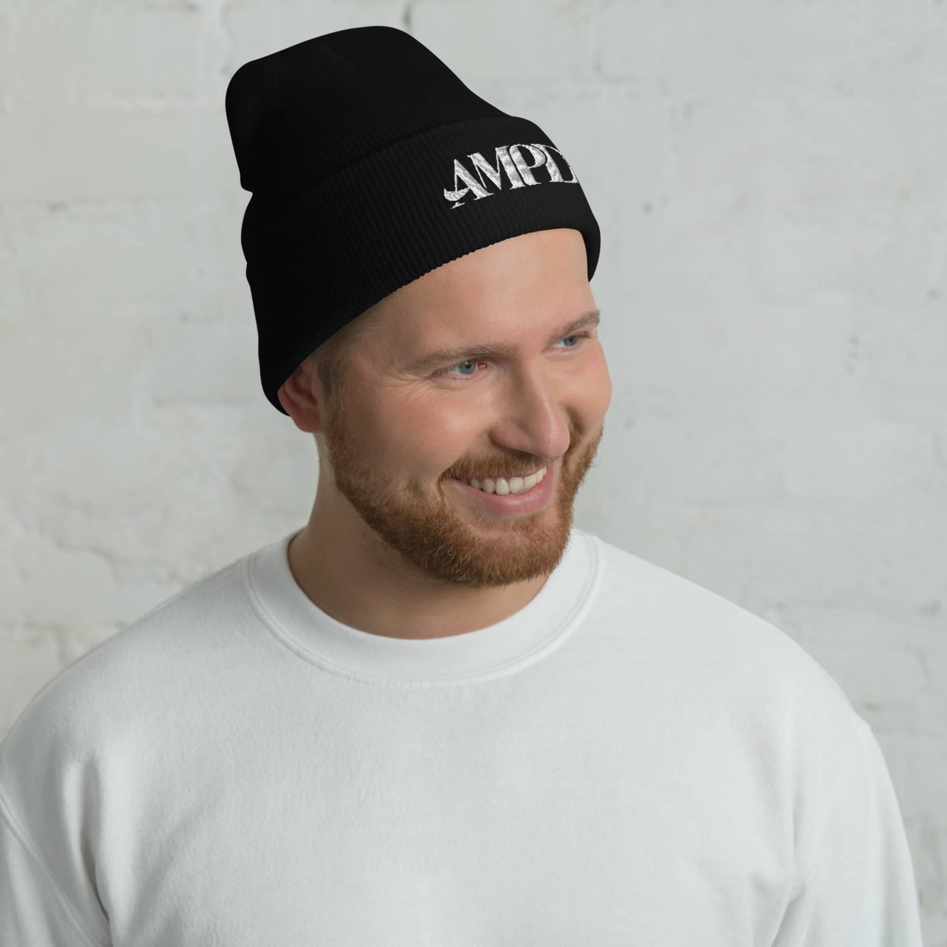 Man wearing an Amp'd Up Logo Cuffed Beanie in black for a stylish and warm look