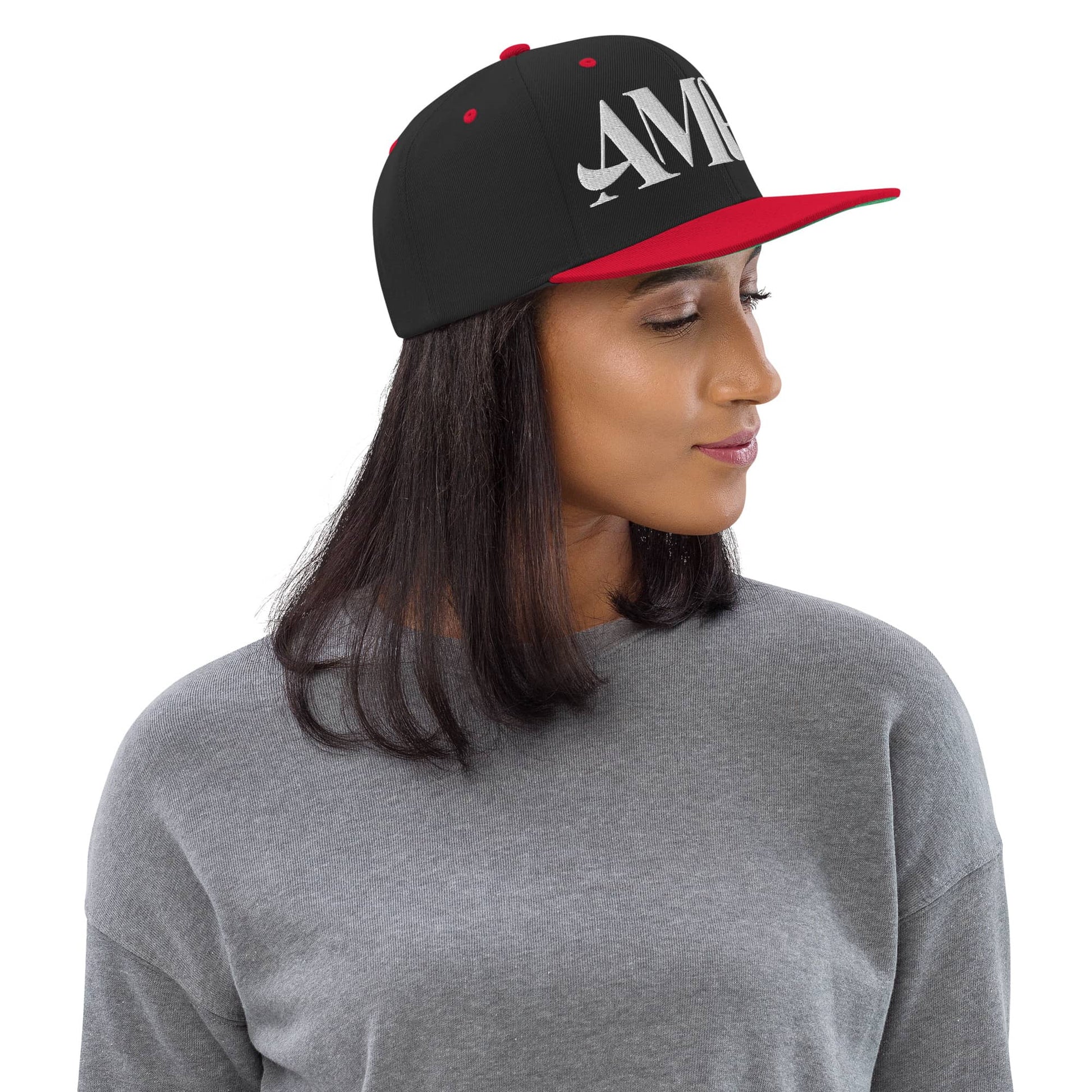 Ampd Up Logo Snapback hat in black and red worn by a model with a gray sweater