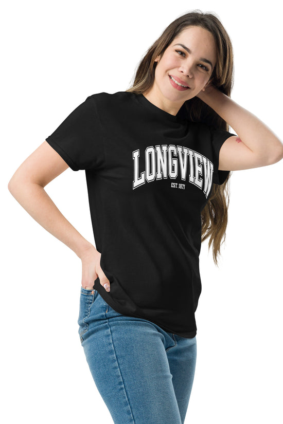 Woman wearing black Longview Texas T-Shirt with white text and blue jeans smiling