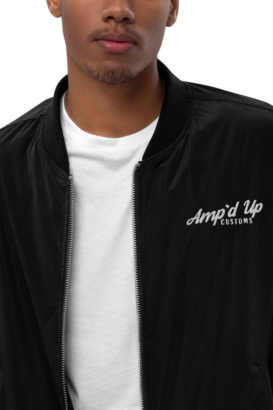 Amp'd Up Premium recycled bomber jacket in black worn by a model with a white shirt