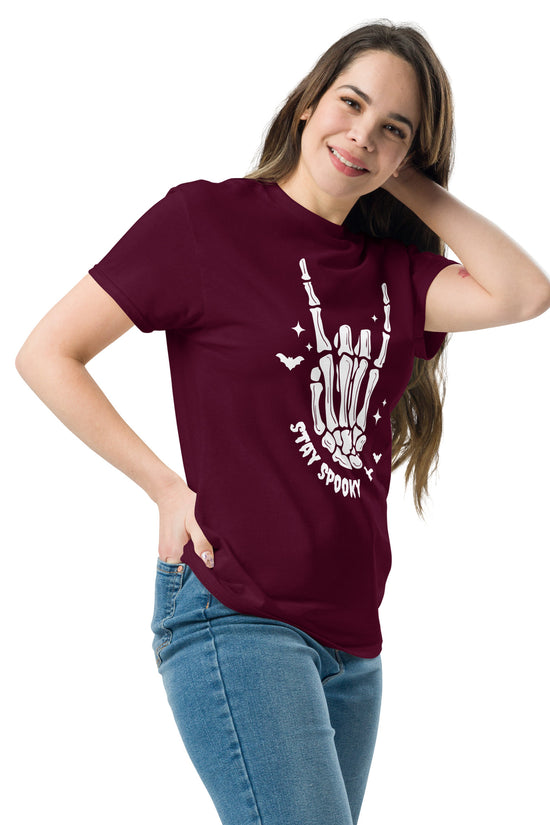 Woman wearing a maroon Stay Spooky T-Shirt with white skeleton hand design from Amp'd Up Custom