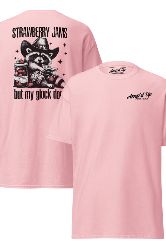 Pink T-shirt featuring Strawberry Jams, But My Glock Don't back illustration with a raccoon design