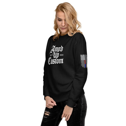 Woman wearing black Amp'd Up Custom EST2024 Sweatshirt crewneck with white logo front and thin line flag sleeve detail