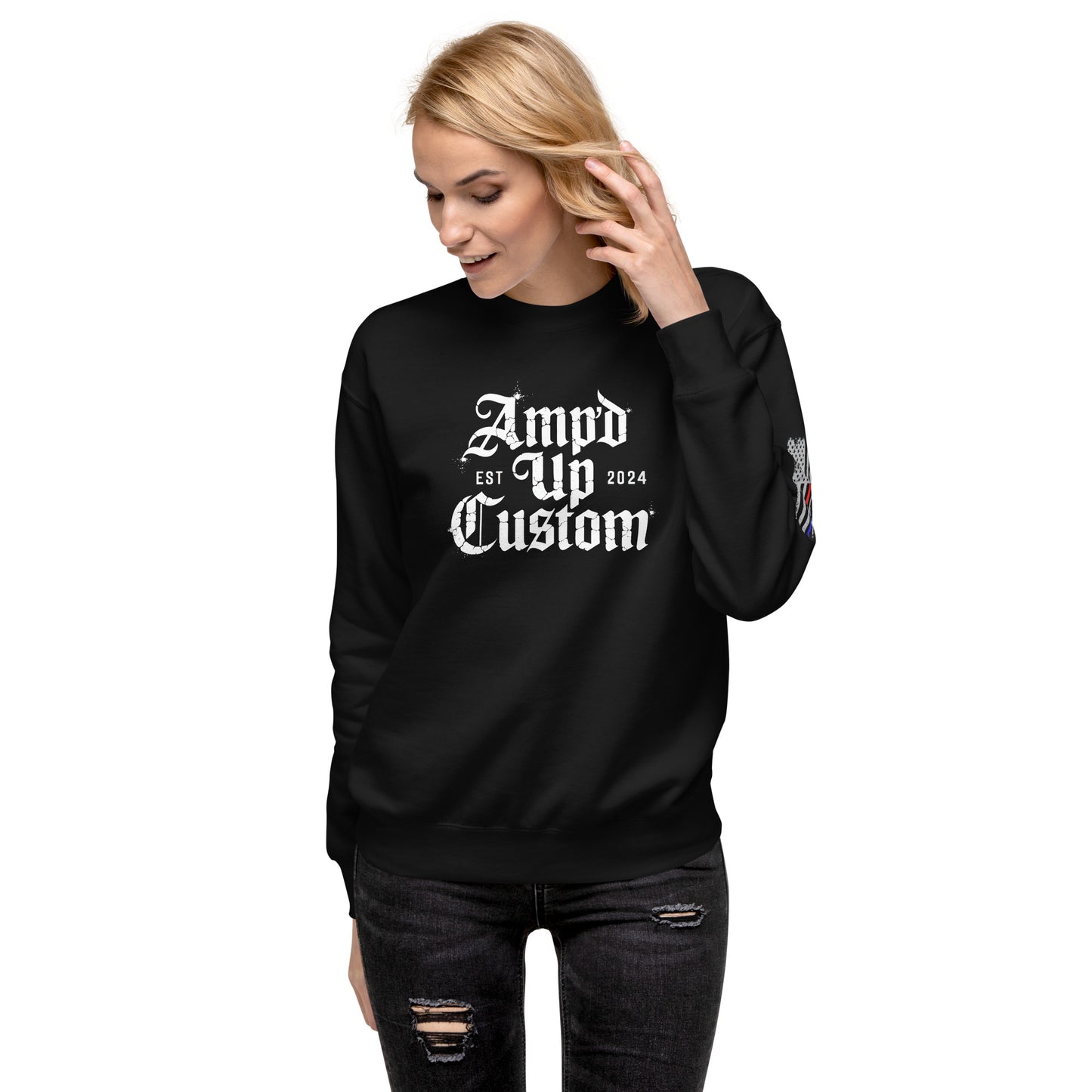 Woman wearing black Amp'd Up Custom EST2024 Sweatshirt with white gothic logo and sleeve patch
