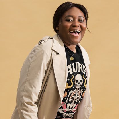 Smiling woman wearing Amp'd Up Custom black AURA Sweatshirt with skeleton graphic and beige jacket