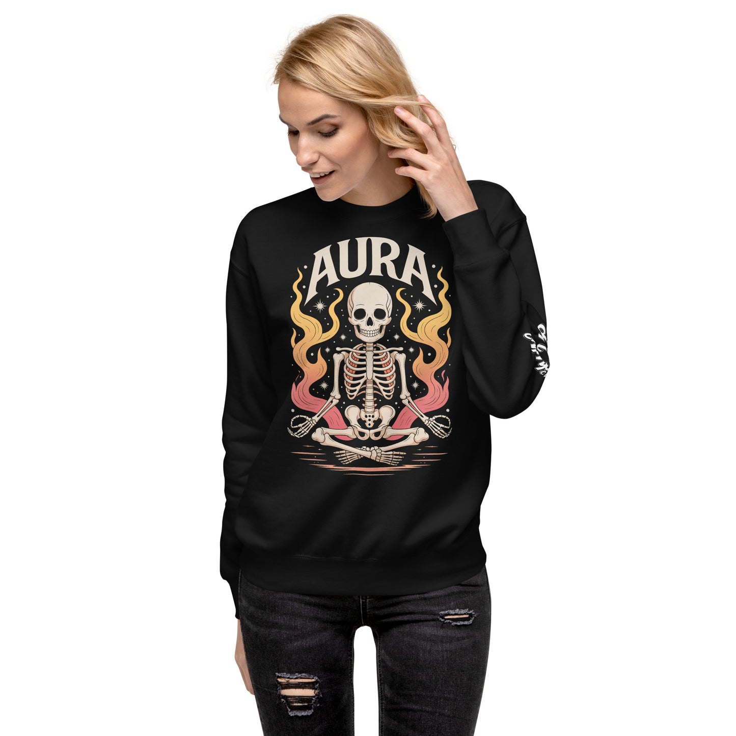 Black AURA Sweatshirt with skeleton and flame design worn by woman in ripped black jeans