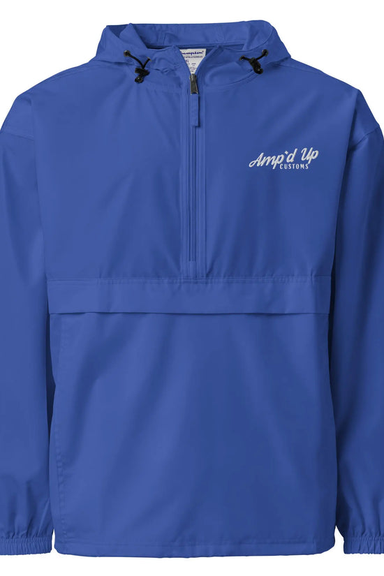 Amp'd Up Embroidered Champion Packable Jacket in blue, featuring a half-zip design and adjustable hood.