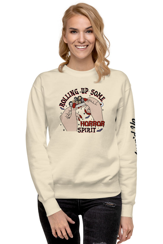 Woman wearing a cream sweatshirt with Amp'd Up Custom Rolling Up Some Horror Spirit Sweatshirt design