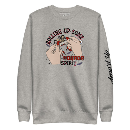 Gray sweatshirt featuring Rolling Up Some Horror Spirit Sweatshirt graphic with hands rolling a joint and Amp'd Up logo on sleeve