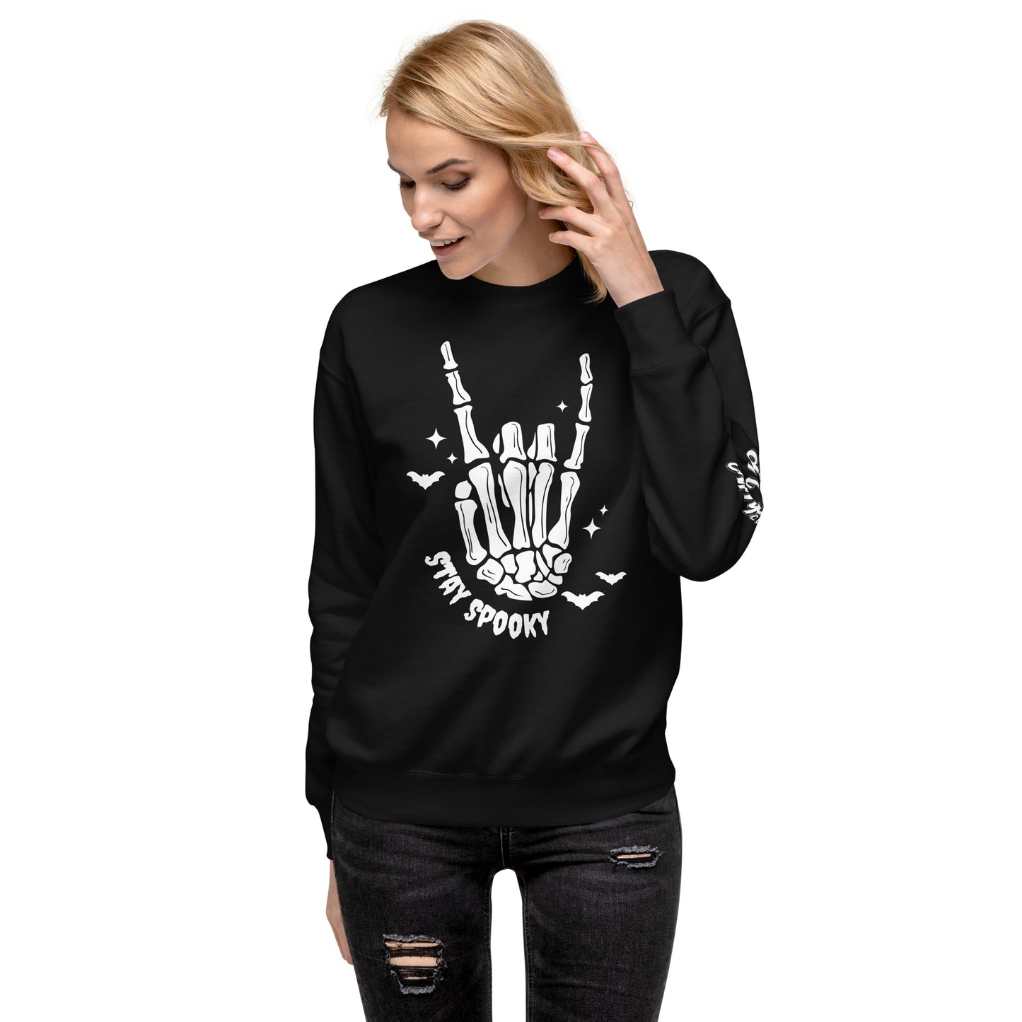 Woman wearing black Stay Spooky Sweatshirt with skeleton hand and bats graphic from Amp'd Up Custom