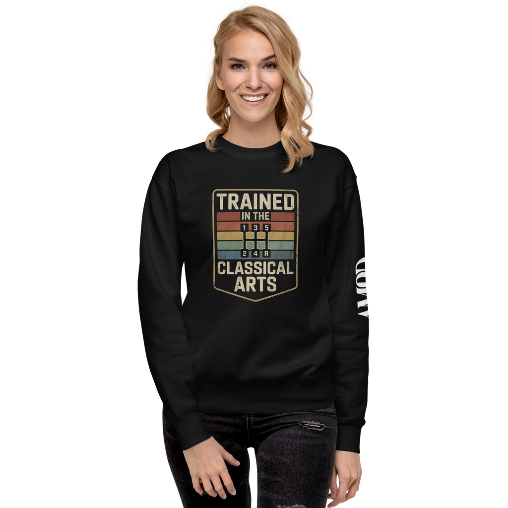 Person wearing a black sweatshirt with 'Trained in the Classical Arts' text and graphic on a white background